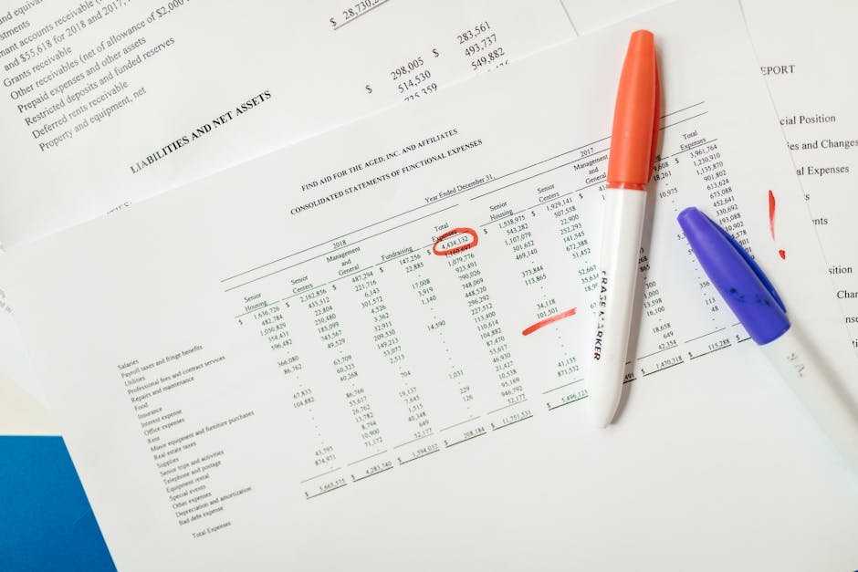 Close-up of financial documents with highlighted figures and marker pens.